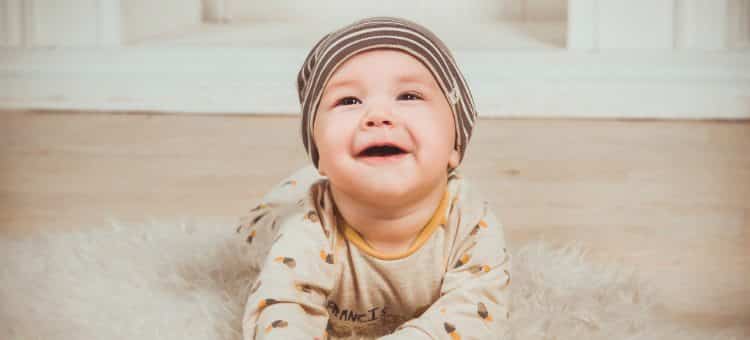 Baby Smiling On Rug