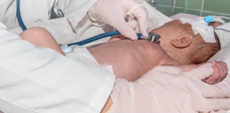 Doctor Checking Infants Heart