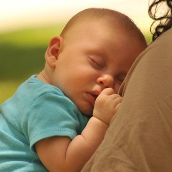 mom holding sleeping newborn